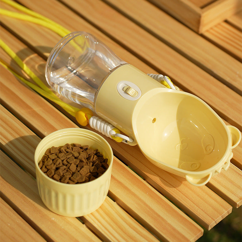Yellow TrailSip bottle and detached food compartment with kibble on an outdoor wooden bench